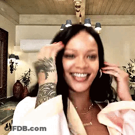 Woman With Arm Tattoo Smiling Touching Hair GIF
