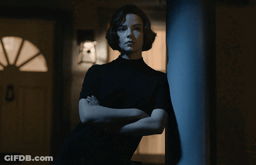 Woman With Arms Crossed Leaning Against Pole GIF