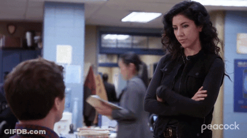 Woman With Arms Crossed Next To Man In Peacock Ad GIF