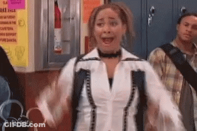 Woman With Arms Outstretched And Backpack In Hallway GIF