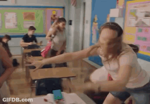 Woman With Arms Outstretched In Classroom GIF