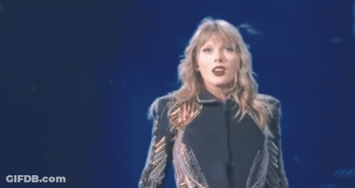 Woman With Arms Outstretched In Sequin Jacket GIF