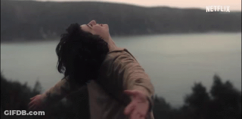 Woman With Arms Outstretched Near Water GIF