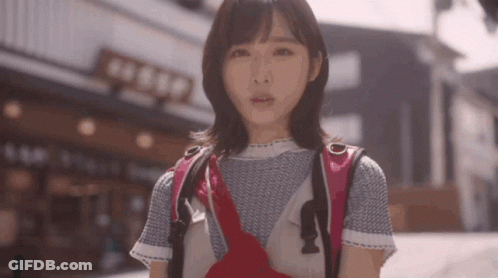 Woman With Backpack In Front Of Building Saying Aeep GIF