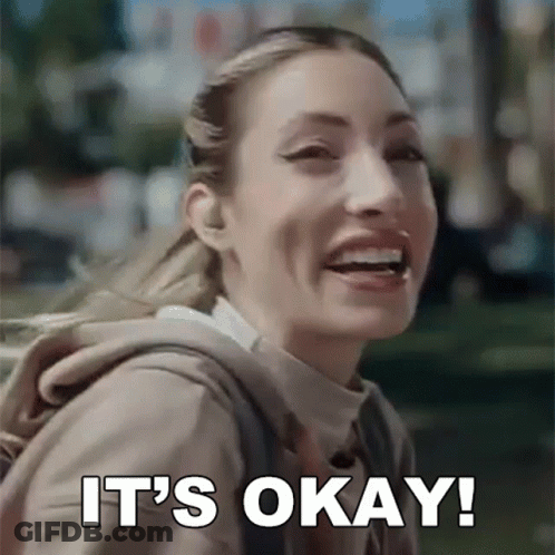 Woman With Backpack Smiling And Saying It's Okay GIF