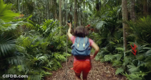 Woman With Backpack Walking Through Jungle GIF