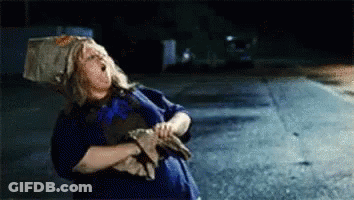 Woman With Bag On Head Standing On Road GIF