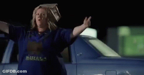 Woman With Bag On Head Walking At Night GIF