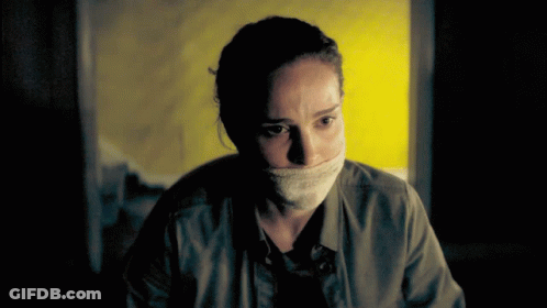 Woman With Bandage Around Mouth Looking At Camera GIF