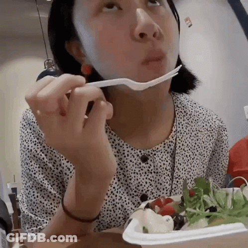Woman With Bandage Eating Salad With Fork GIF