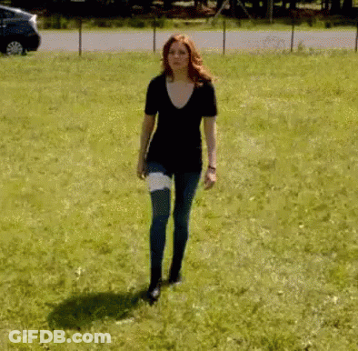 Woman With Bandage Walking In Grassy Field GIF