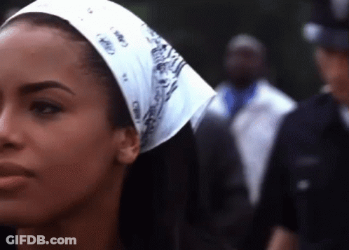 Woman With Bandana Standing Before Police Officer GIF