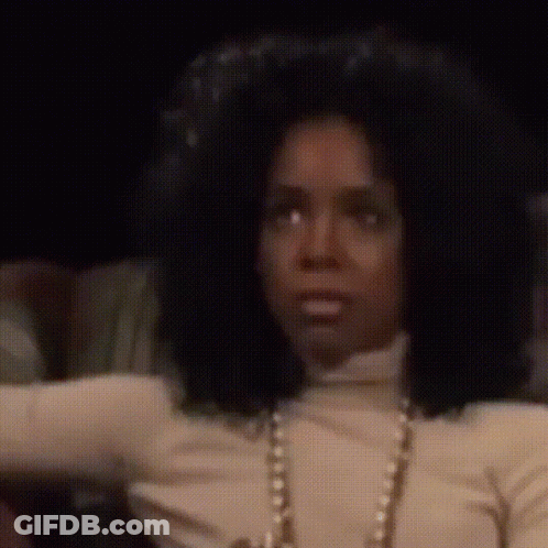Woman With Big Afro In White Turtleneck And Pearls GIF