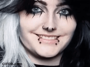 Woman With Black And White Hair And Piercings GIF