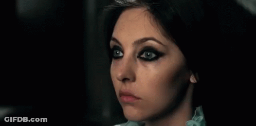Woman With Black Eyeliner And Blue Shirt GIF