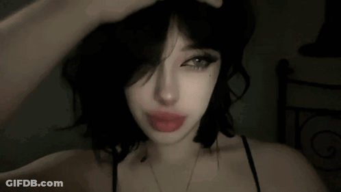 Woman With Black Hair And Red Lips Hand To Head GIF