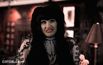 Woman With Black Hair And Red Lips Making A Face GIF