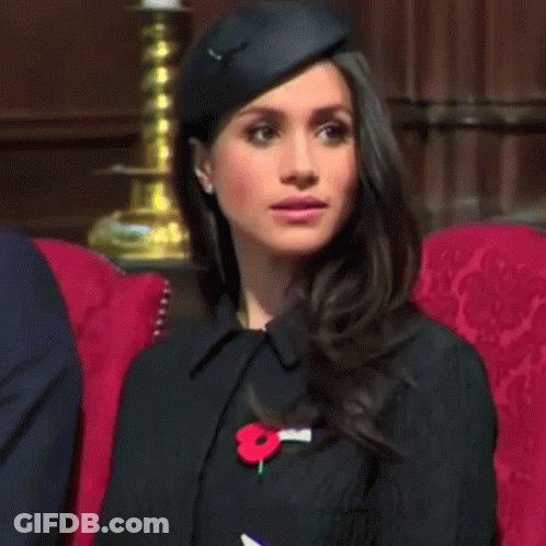 Woman With Black Hat And Red Poppy Pin In Red Chair GIF