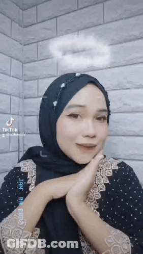 Woman With Black Hijab And Black Dress Making Face GIF