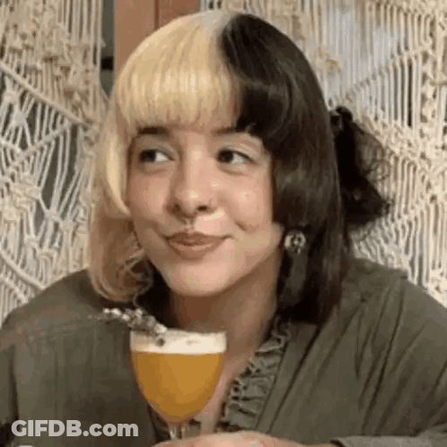 Woman With Blonde And Black Hair Smiling Holding Beer GIF