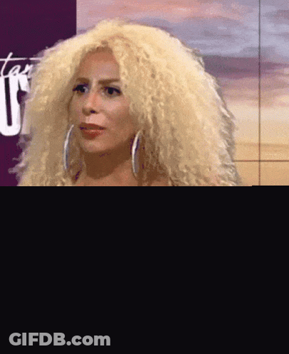 Woman With Blonde Curly Hair In Black And White Dress GIF