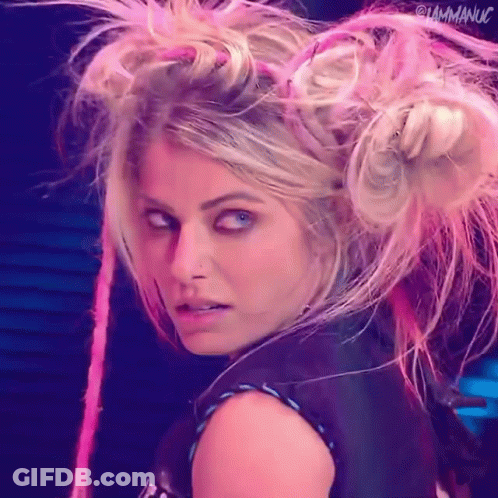Woman With Blonde Hair And Pink Dreadlocks Looking At Camera GIF