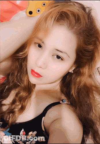 Woman With Blonde Hair And Red Lipstick Lying GIF