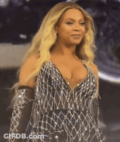 Woman With Blonde Hair In Revealing Dress And Gloves GIF