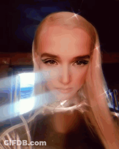 Woman With Blonde Hair Looking At Camera GIF