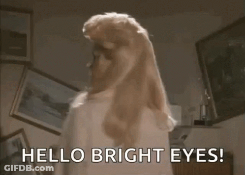 Woman With Blonde Hair Saying Hello Bright Eyes GIF