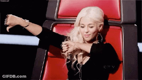 Woman With Blonde Hair Sitting In Red Chair GIF