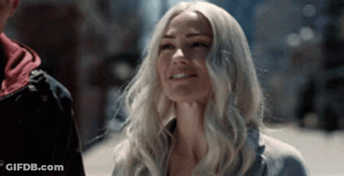 Woman With Blonde Hair Standing Next To Man On City Street GIF