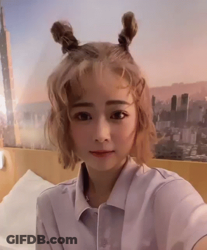 Woman With Blonde Hair Taking Selfie GIF