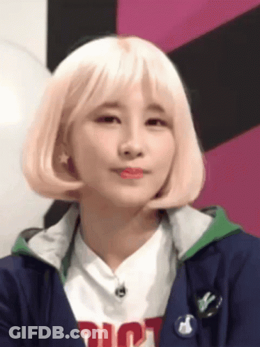 Woman With Blonde Hair Wearing Dior Shirt And Blue Jacket GIF