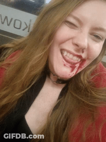Woman With Blood Smiling In Front Of Wok Sign GIF