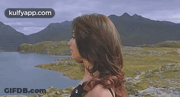 Woman With Blowing Hair By Lake And Mountains GIF