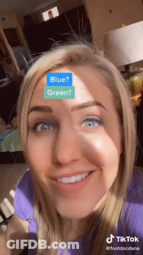 Woman With Blue And Green Sticker On Face GIF
