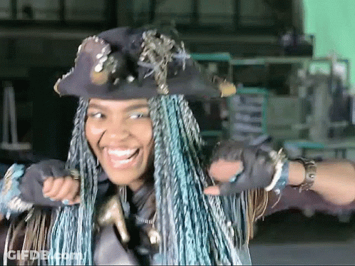 Woman With Blue Braids Wearing Hat And Gloves GIF