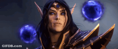 Woman With Blue Eyes And Crown Surrounded By Blue Spheres GIF