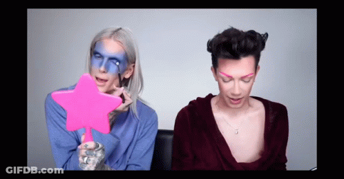 Woman With Blue Face Paint Holding Pink Star Mirror GIF