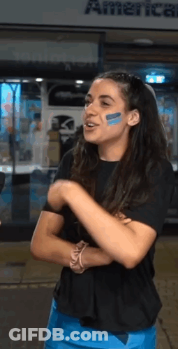 Woman With Blue Face Paint In Front Of American Airlines GIF