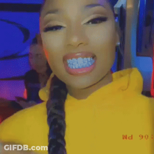 Woman With Blue Grills On Teeth In Yellow Hoodie And Braided Hair GIF