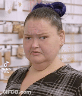Woman With Blue Hair Bun Making Funny Face GIF
