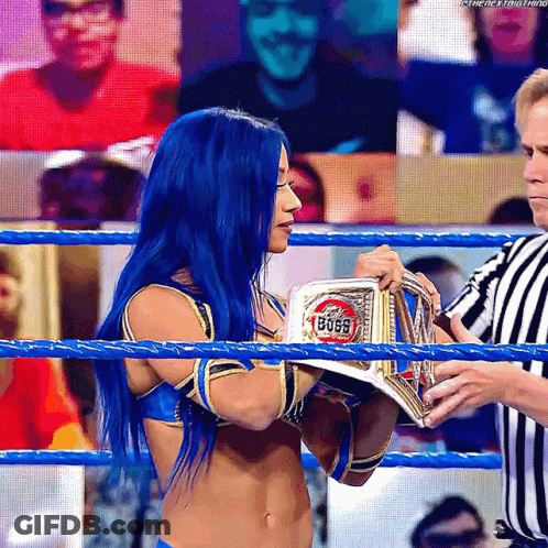 Woman With Blue Hair Holding Boss Belt In Wrestling Ring GIF