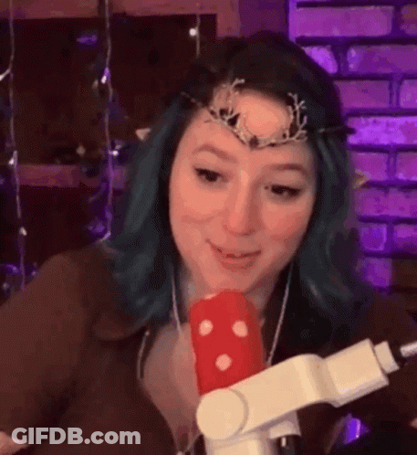 Woman With Blue Hair Holding Microphone And Crown GIF