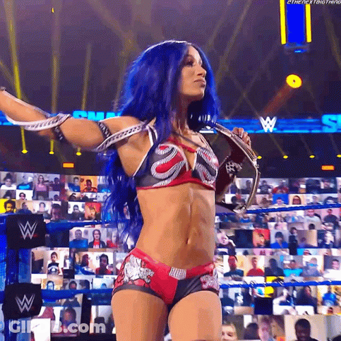 Woman With Blue Hair Holding Microphone At Wrestling Event GIF