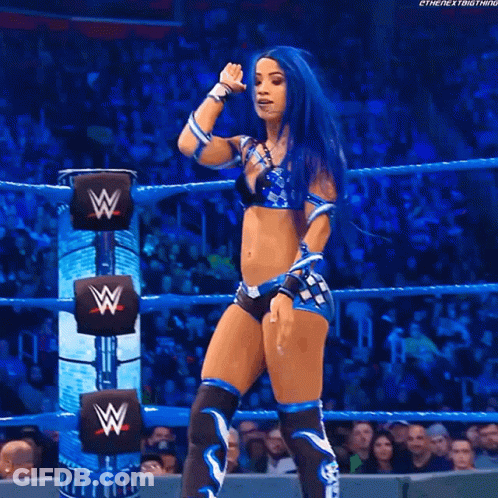 Woman With Blue Hair In Wrestling Ring With W On Back GIF
