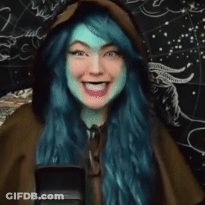 Woman With Blue Hair Laughing At Microphone GIF
