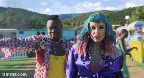 Woman With Blue Hair Next To Man In Yellow Tank Top GIF
