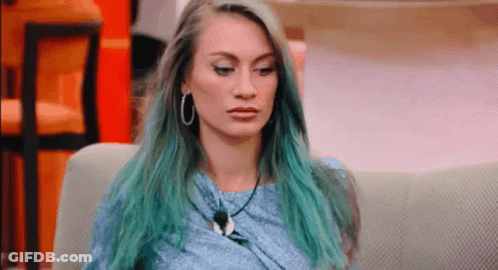 Woman With Blue Hair On Couch Looking At Camera GIF
